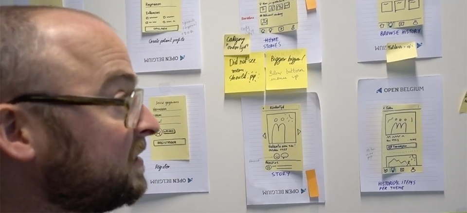 Interface sketches with sticky notes on the wall